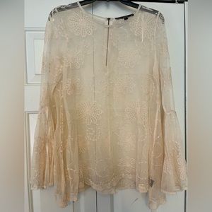 Women’s sheer blush top with floral pattern.